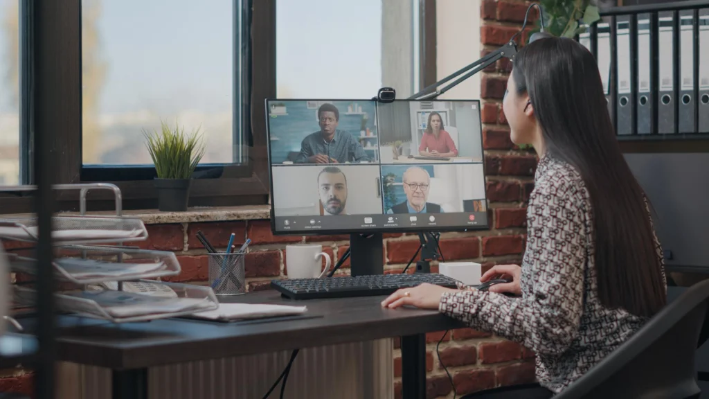 Employee talking with workmates on a video call meeting