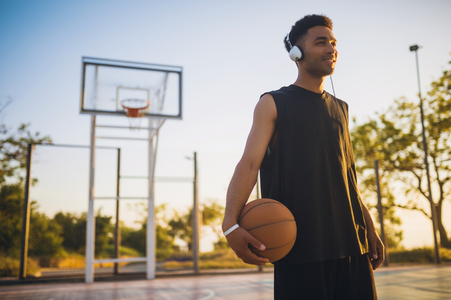 Person holding a basketball and listening to music