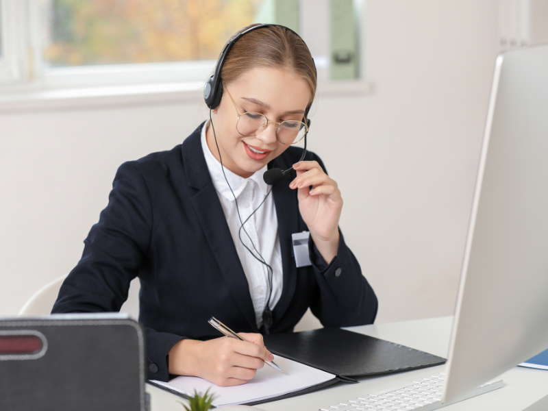 call center agent writing while on a call