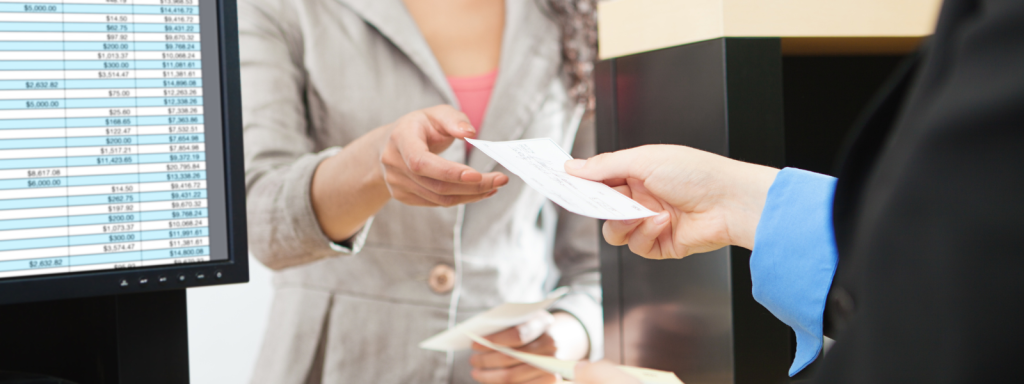 businessman handing out a receipt to a businesswoman