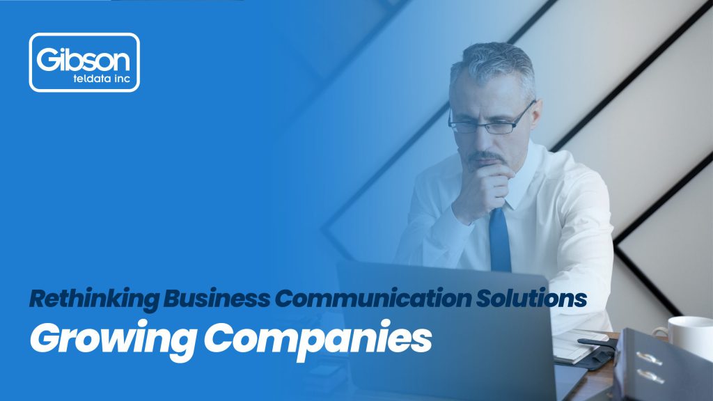 A professional man in a white shirt and blue tie looks intently at his laptop. The banner promotes Gibson Teldata Inc.’s business communication solution, designed to support the growth of modern companies.