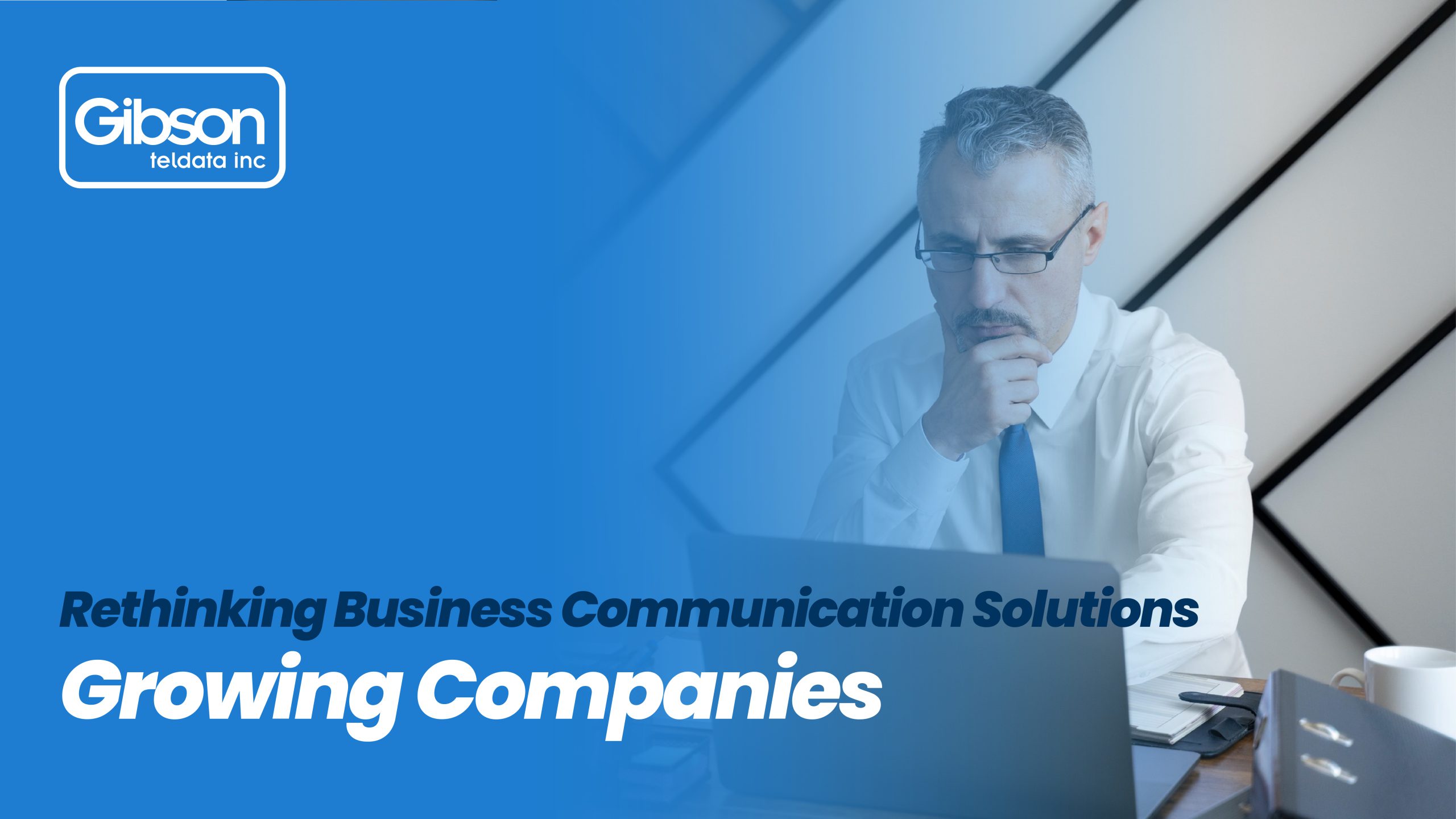 A professional man in a white shirt and blue tie looks intently at his laptop. The banner promotes Gibson Teldata Inc.’s business communication solution, designed to support the growth of modern companies.